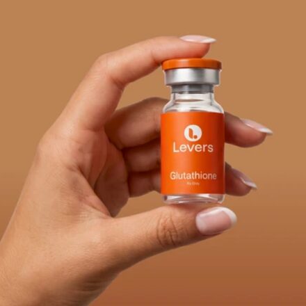 Hand holding a Levers Glutathione vial
