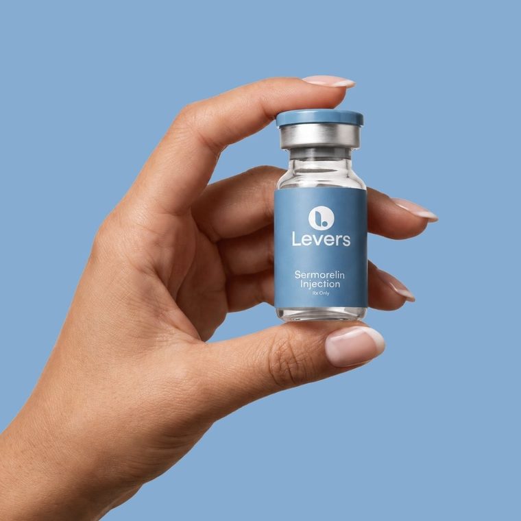 Levers Sermorelin vial held between finger and thumb